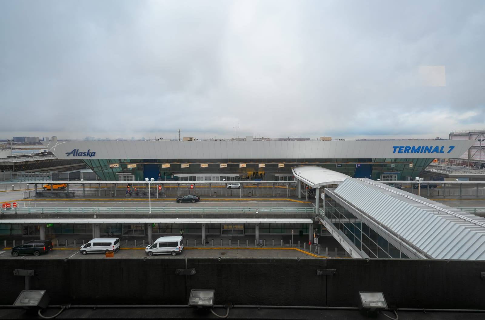 The JFK Terminal 7 frontage, its two-level departures roadway almost empty on an overcast day